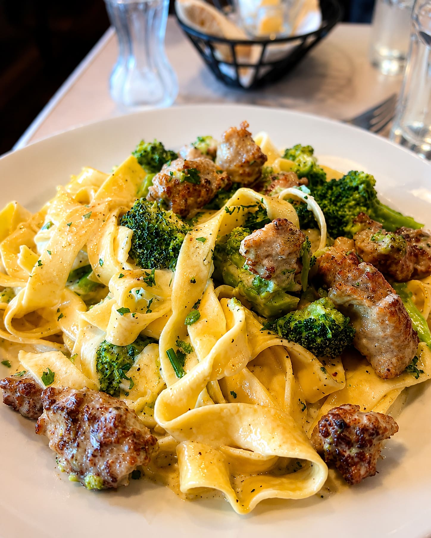 Fettuccine with crumbled sausage and broccoli in a light cream sauce.